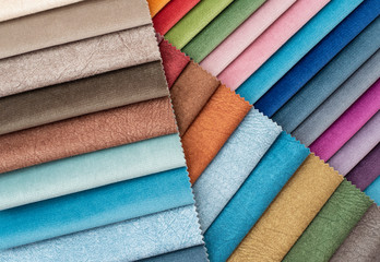 Colorful and bright curtains fabric pattern palette texture samples as abstract textile background. Handmade, clothes and furniture decoration concept. Scraps of colored tissue close up