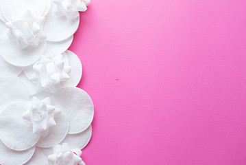 cotton pads on pink background, top view. Beauty, skin, body care concept.selective focus. place for text. frame