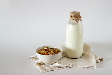 A bottle of milk and Granola on a white background.