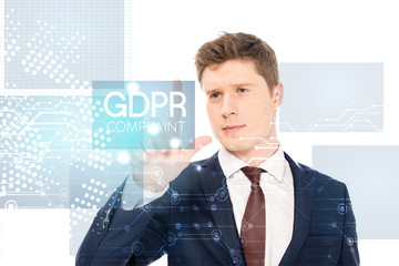 successful businessman in suit pointing with finger at gdpr compliant illustration on white background