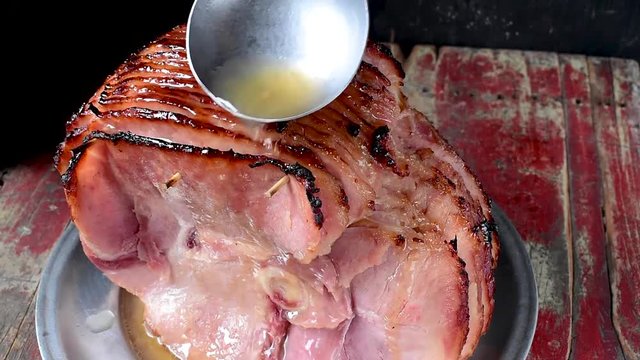 ladle juice over baked spiral cut ham
