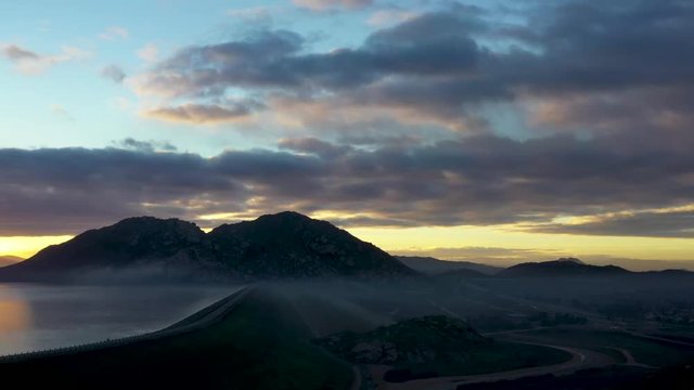 A sunrise slow 3D looking pan with mountains,clouds and the lake.