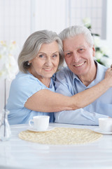 Close-up portrait of happy senior couple at home