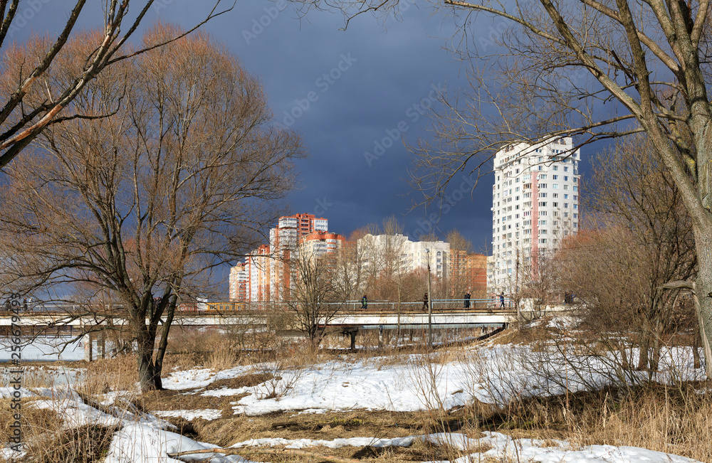 Wall mural View of the city park, footbridge over Pekhorka river and new residential neighborhood. City of Balashikha, Russia.