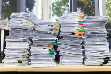 Business and finance concept of office working, Pile of unfinished documents on office desk, Stack...