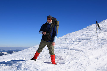 Fototapeta na wymiar Tourist in the winter mountains