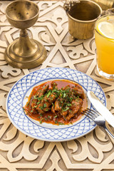 Meat stew with greens on oriental table background