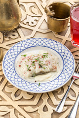 White fish fillet baked with white sauce on oriental table