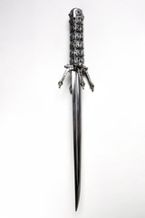 Closeup of vintage metal sword decorated with gems isolated on white background