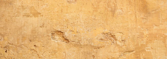 Beige yellow color, painted and faded wall texture grunge background