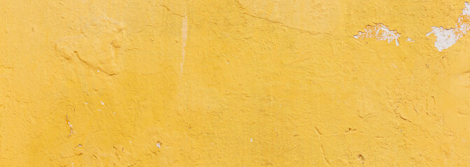 Yellow color, painted and faded wall texture grunge background