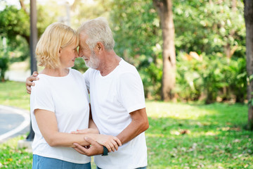 Senior Caucasian Women and men Standing in garden during summer Which is lover who has been caring for long time Take care of health And travel together in retirement Concepcion insured the elderly