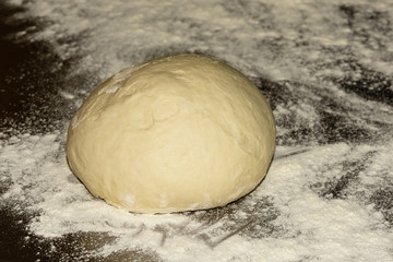 Fresh raw dough for pizza or bread baking on metal background. Close up. Selective focus.