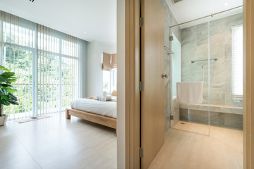  Luxury Interior design in modern bedroom with hallway bathroom of pool villa with cozy king bed...