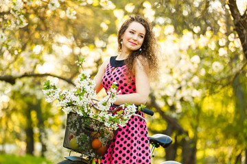 Woman with gorgeous smile having fun in blooming garden. Female on natural background, wellness and...