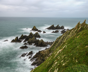 Fototapeta na wymiar Sharp rocks in the shallows of the coast