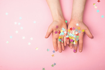 Gold glitter stars on children's hands.