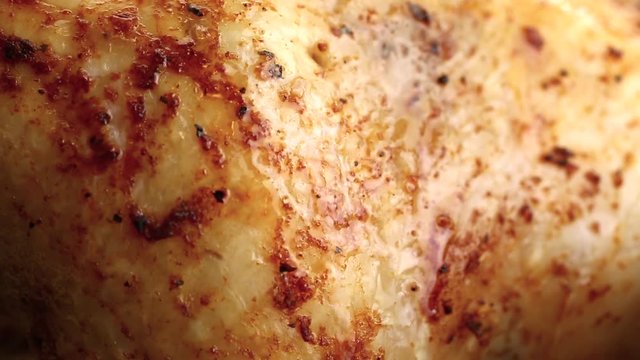 Close-up of grilled chicken with a fork side view