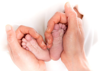 Daddy's hands holding his son's feet