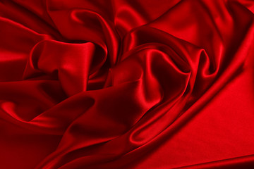 Obraz premium Red silk or satin luxury fabric texture can use as abstract background. Top view.