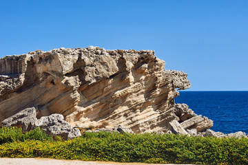 rocky cliff at the edge of the Mediterranean Sea, on the island of Rhodes.