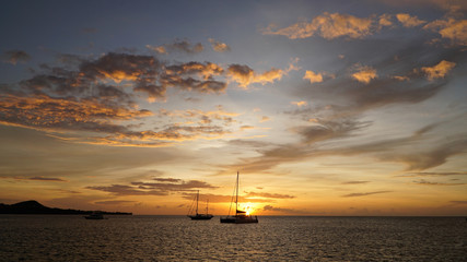 Morris M46 Yacht during sunset with orange sky in the Caribbean Sea near Union Island.