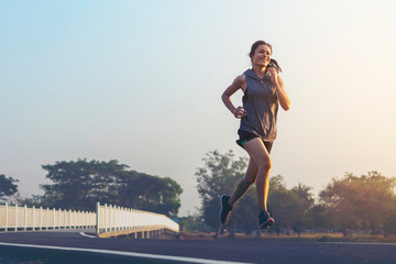 young woman runner running on road. healthy lifestyle young fitness woman running
