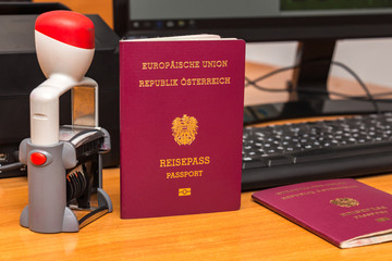 Close-up of Austrian biometric passport with a date stamper, interstate border in Europe. Inscription - European Union, Republic of Austria, Passport. Border crossing, travel, immigration concept