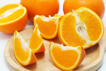 Group of slice oranges on wood plate