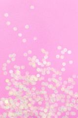 Flat lay paper round confetti on pastel pink background top view. Festive holiday background, concept of party, birthday, christmas or new year. Copyspace for text