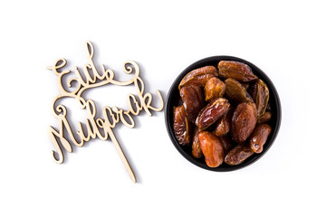 Dates and Eid Mubarak message isolated on white background. Top view
