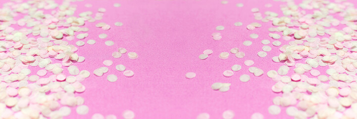 Obraz na płótnie Canvas Flat lay paper round confetti on pastel pink background top view. Festive holiday background, concept of party, birthday, christmas or new year. Copyspace for text