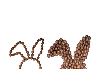 Easter holiday background with bunny ears made of freshly roasted coffee beans on a white background. Creative easter concept. Copy space.