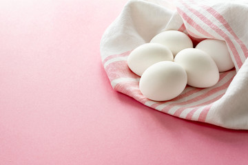 eggs white on a pink background wrapped towel, happy Easter
