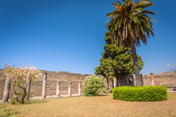 Fototapeta na wymiar Ruins of Pompeii fragment of courtyard with columns