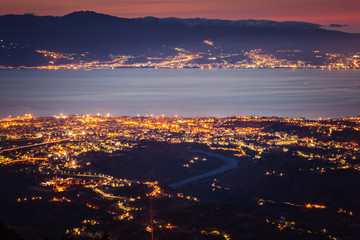 Messina strait and Reggio Calabria city lights at dusk - obrazy, fototapety, plakaty