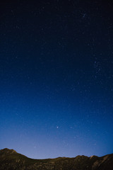 The Transfagarasan highway in Romania at night time, long exposure photography by moonlight, vertical photo