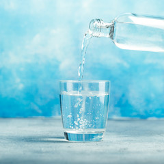 Pouring water from bottle into glass