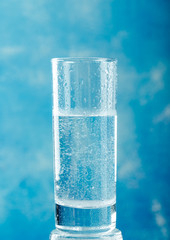 Water glass on blue background