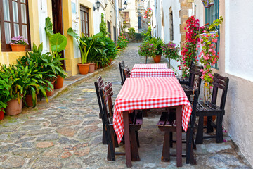 View of outdoor Cafe on narrow Street in the old European Mediterranean city