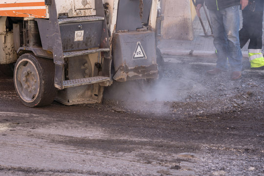 Asphalt Milling Machine Working Around A Sewer Lid