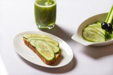 Sandwich with fresh cucumber , juice from a celery. Healthy lifestyle. Selective focus.
