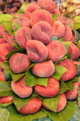Ripe red flat peach for sale at the farmers fruit market