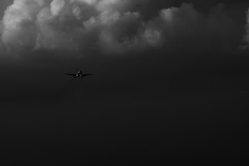 airplane flying in the sky with clouds