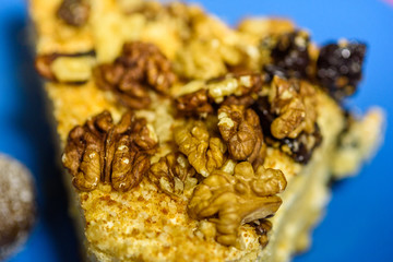 A slice of sponge cake with walnuts close-up.