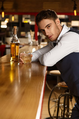 The last guest. Vertical portrait of a handsome sexy man looking passionately to the camera