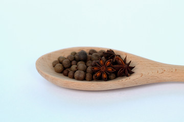 Spices in wooden spoons on white background.