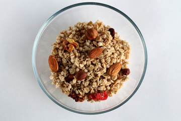 Bowl of cereal with fresh fruits and nuts.