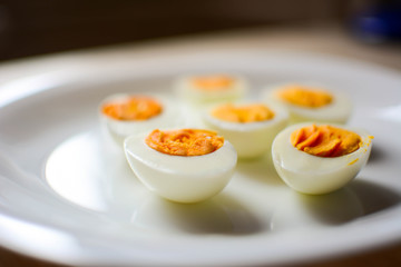 Plate of freshly boiled eggs isolated on wooden table. Aerial view. Copy space. Horizontal.