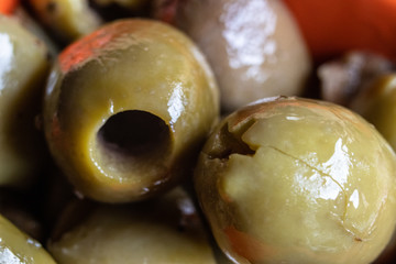 Macro shot of green olives with spices for pizza